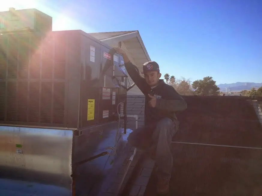 HVAC technician performing HVAC Inspection on a rooftop unit in Columbus
